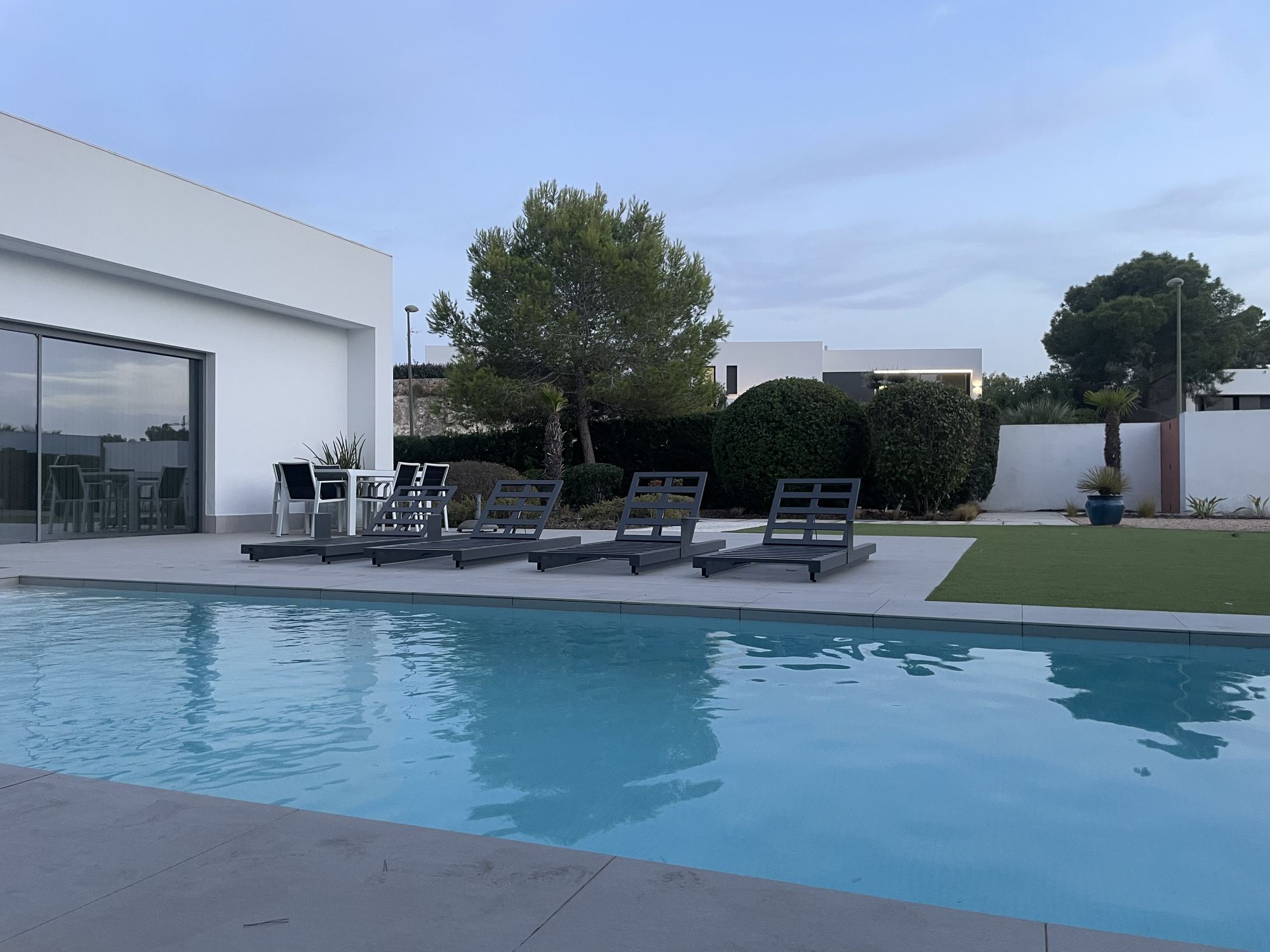Villa pool and garden at dusk in Las Colinas Golf